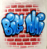 Close-up of original Big Ni airbrush artwork: blue bubble graffiti letters with white highlights and black shadows over a red brick wall on white fabric.