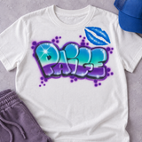 White T-shirt mockup with Paige turquoise-and-purple bubble graffiti and blue lips, styled with purple pants and a blue hat; accessories not included.